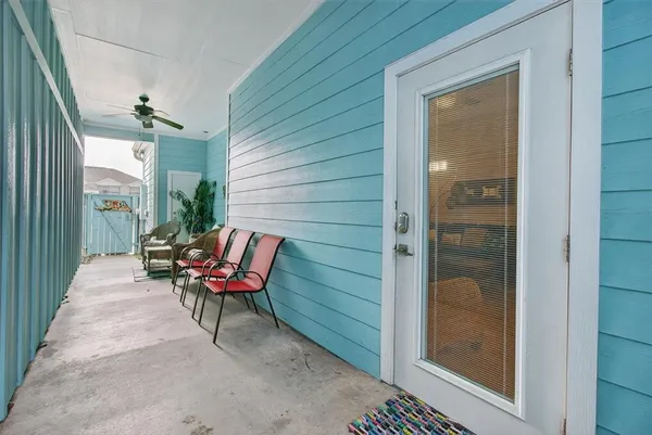 a balcony with couple of chairs and a couch