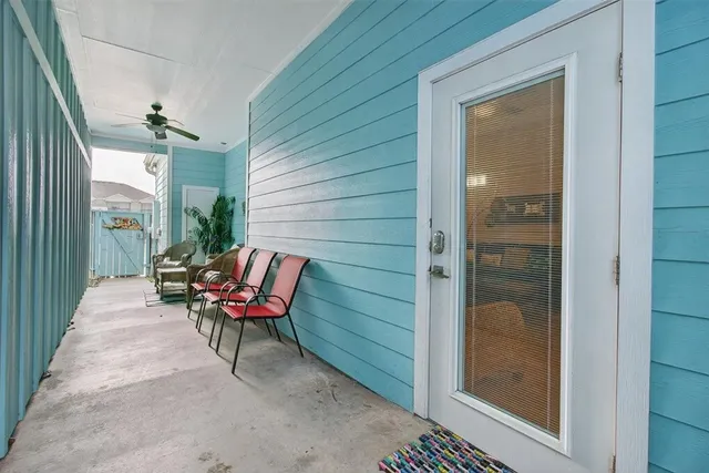 a balcony with couple of chairs and a couch
