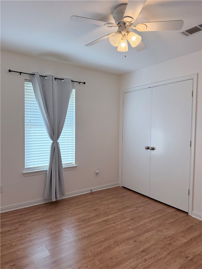 1029 Fallbrook Loop College Station, TX 77845 - Photo 26 of 34 an empty room with wooden floor and windows