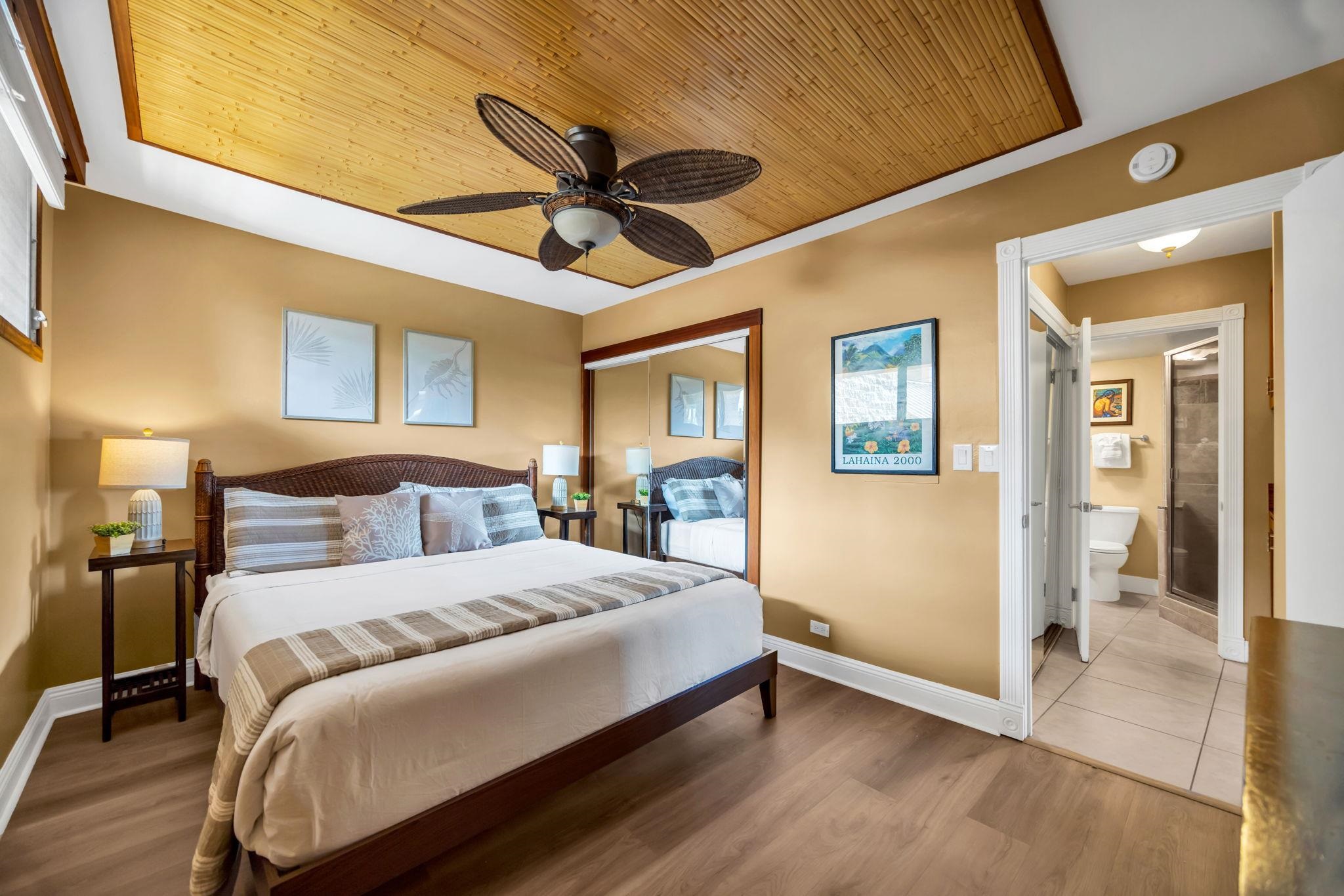 3615 Lower Honoapiilani Road, Unit 222 Lahaina, HI 96761 - Photo 16 of 50 a bedroom with a large bed chandelier and a window