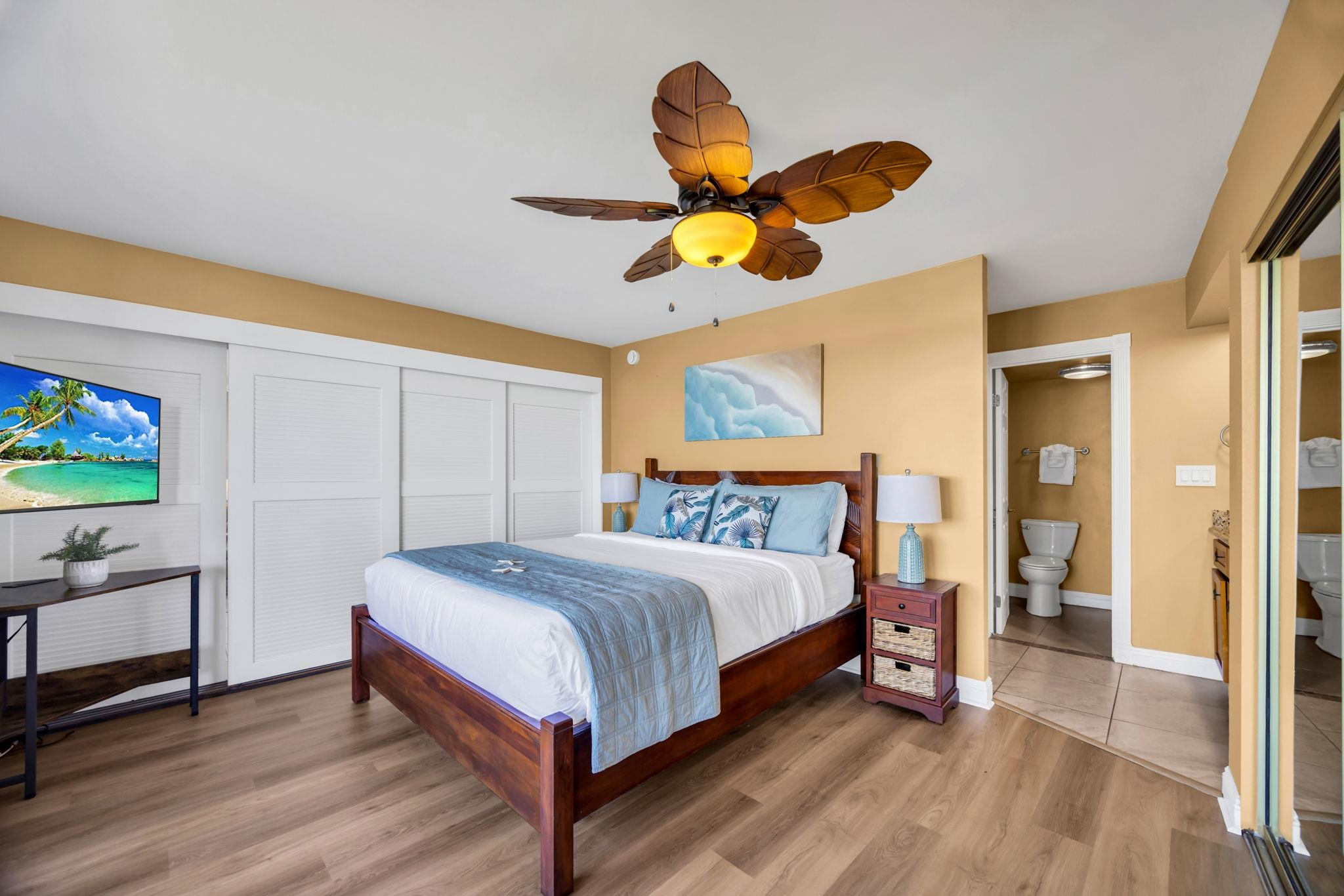 3615 Lower Honoapiilani Road, Unit 222 Lahaina, HI 96761 - Photo 20 of 50 a bedroom with a bed a chandelier and dresser