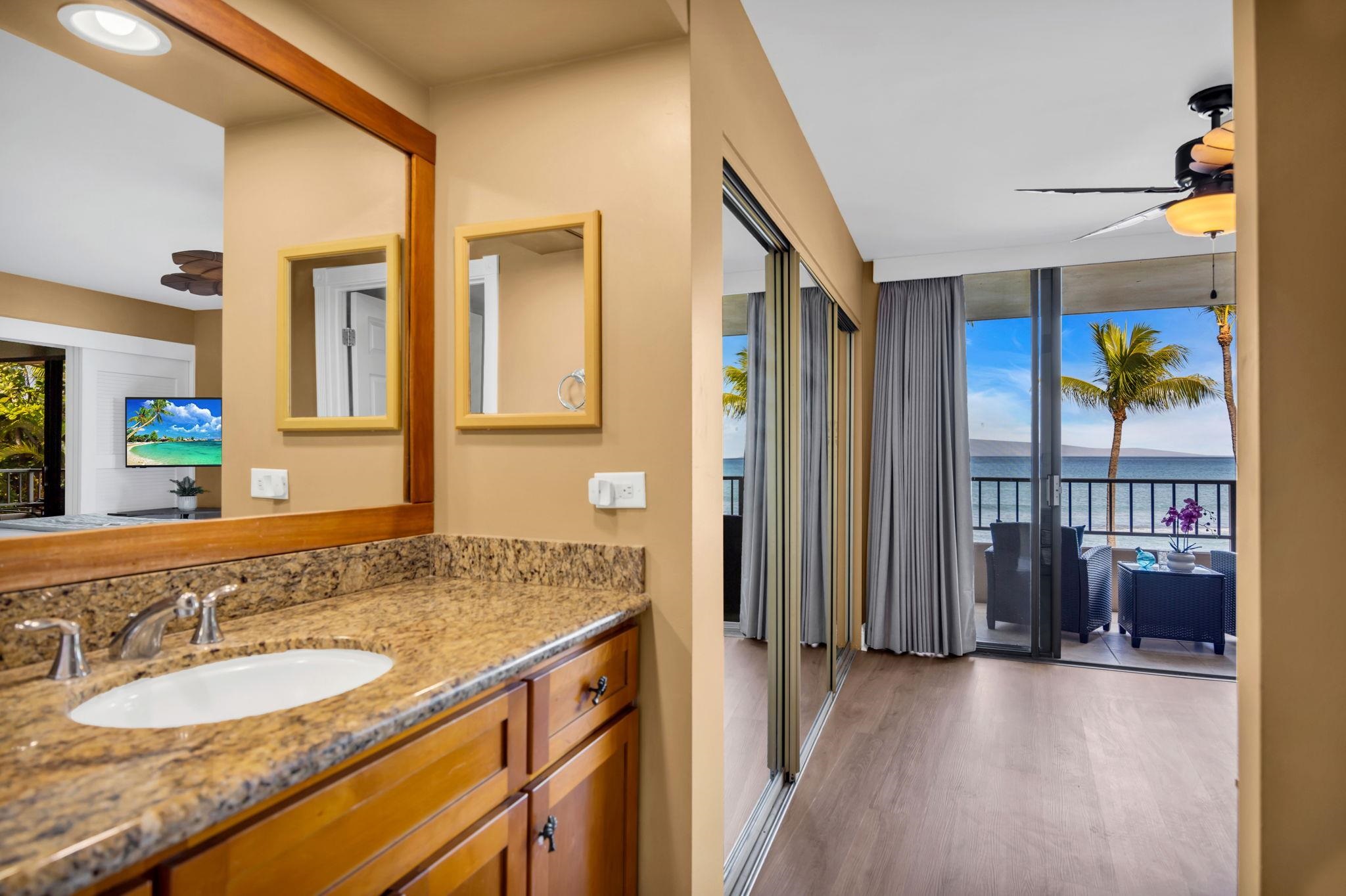 3615 Lower Honoapiilani Road, Unit 222 Lahaina, HI 96761 - Photo 24 of 50 a spacious bathroom with a granite countertop sink and a mirror