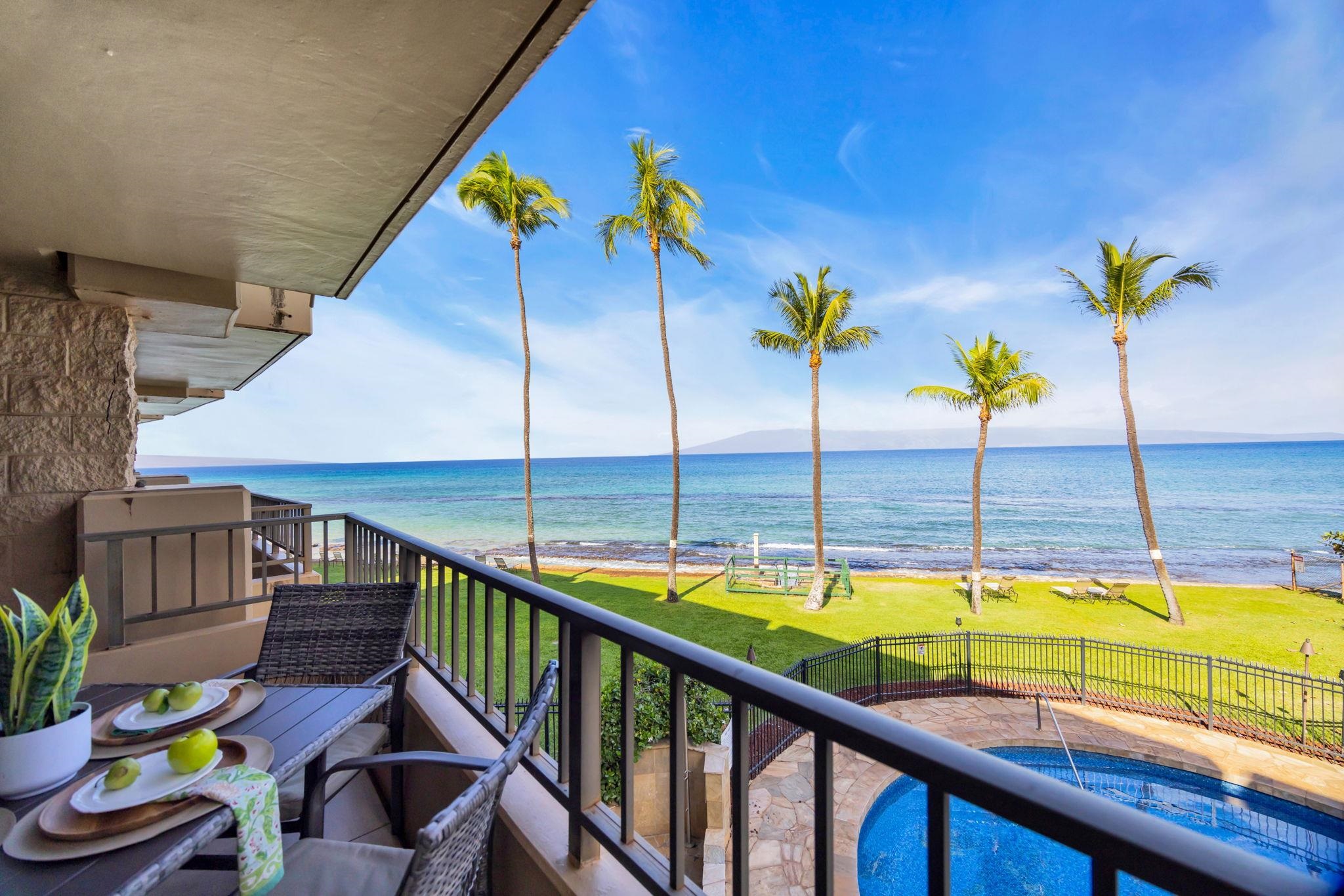 3615 Lower Honoapiilani Road, Unit 222 Lahaina, HI 96761 - Photo 34 of 50 a view of a swimming pool with a lounge chairs
