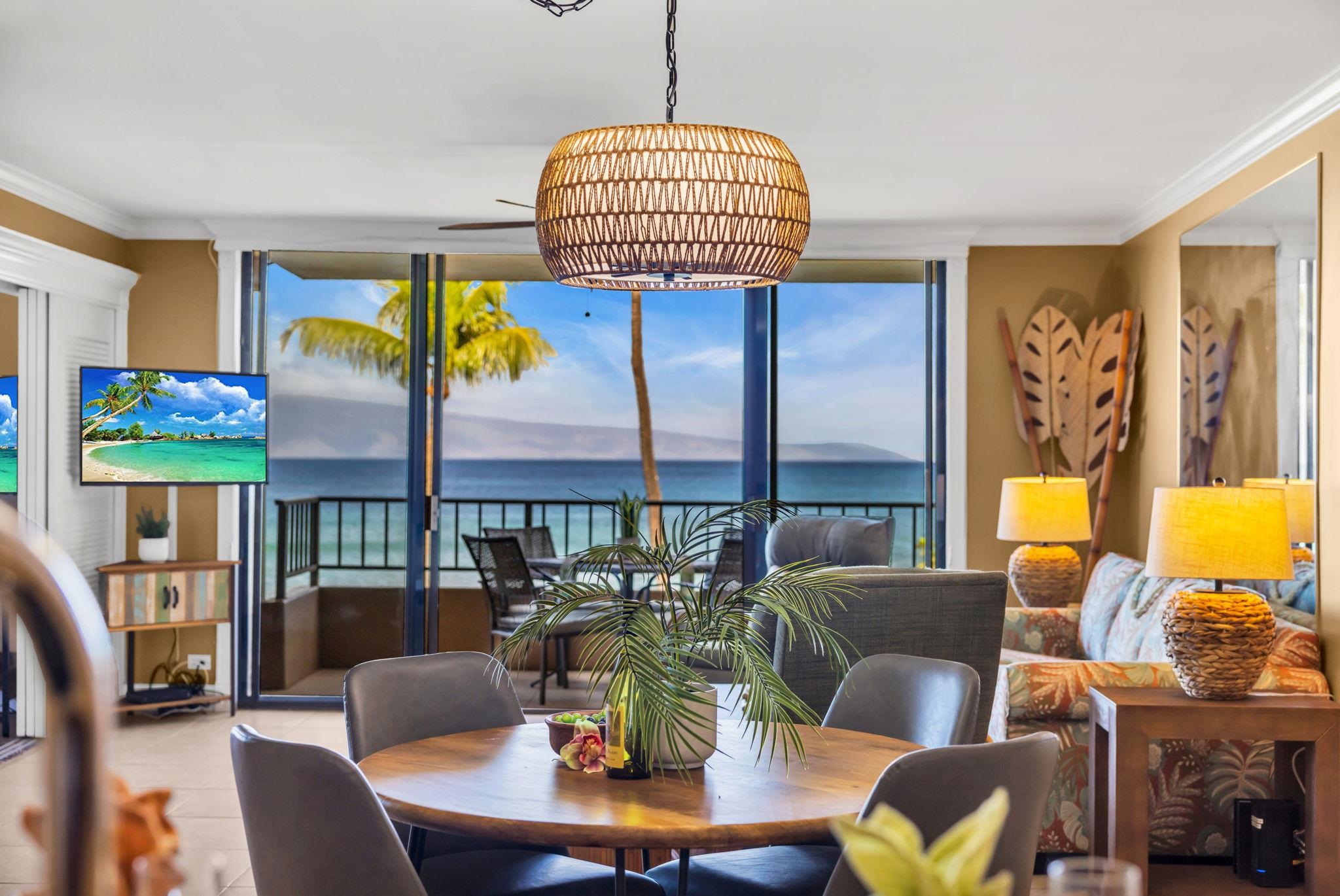 3615 Lower Honoapiilani Road, Unit 222 Lahaina, HI 96761 - Photo 4 of 50 a dining room with furniture a rug and a chandelier