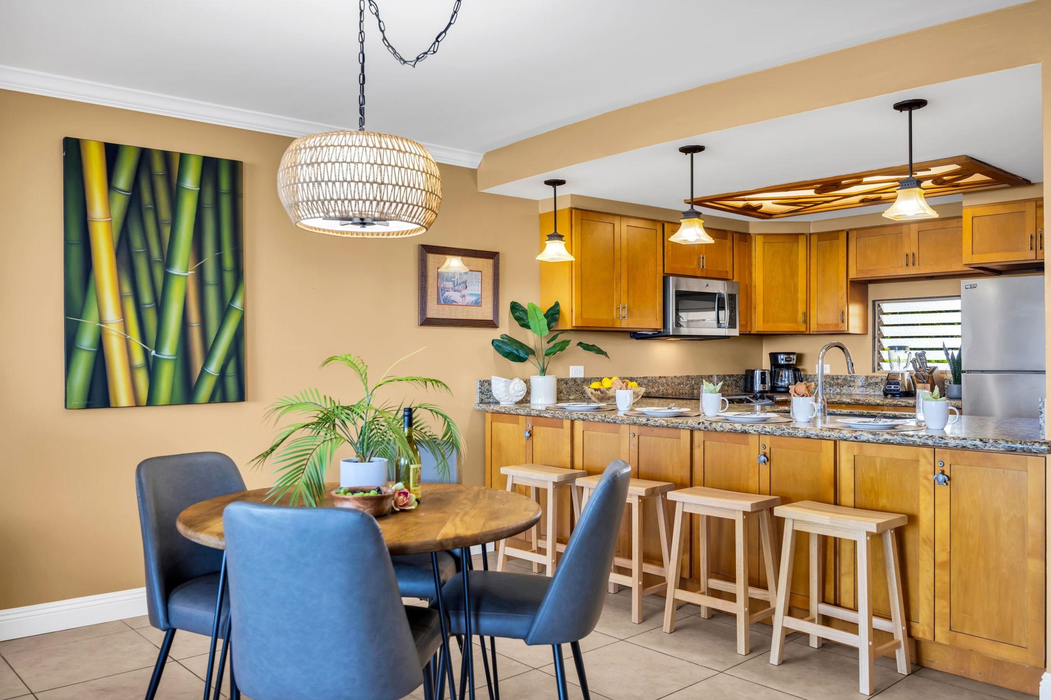 3615 Lower Honoapiilani Road, Unit 222 Lahaina, HI 96761 - Photo 48 of 50 a dining room filled chandelier and wooden furniture