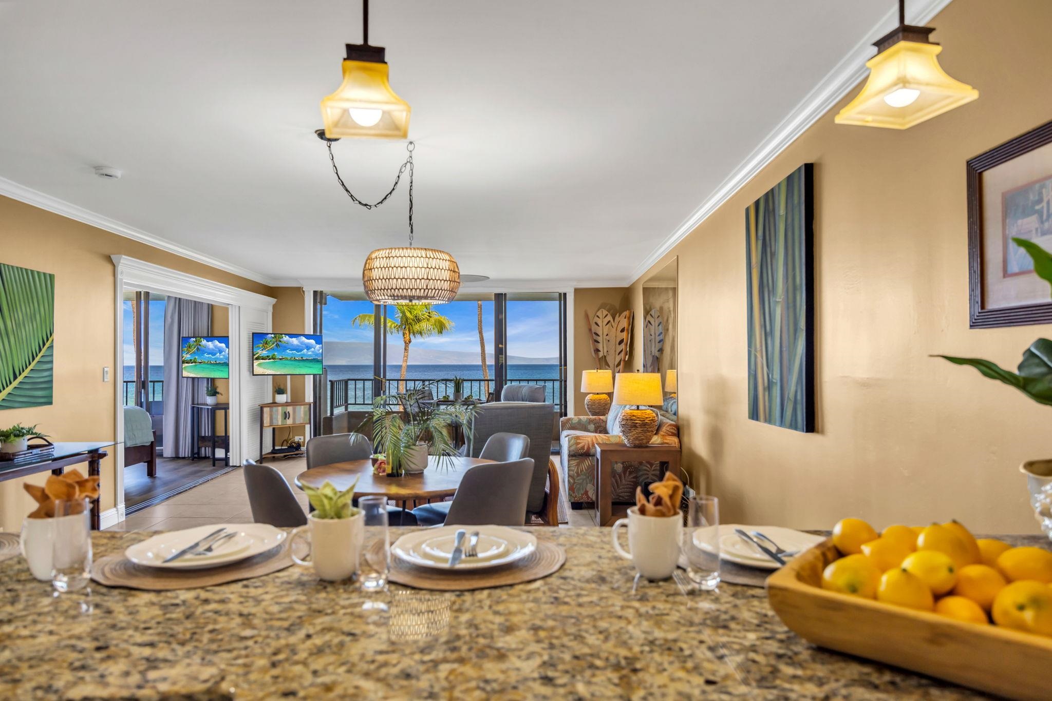 3615 Lower Honoapiilani Road, Unit 222 Lahaina, HI 96761 - Photo 9 of 50 a room with furniture a chandelier and wooden floor