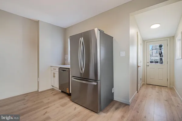 a view of a refrigerator in kitchen and wooden floor