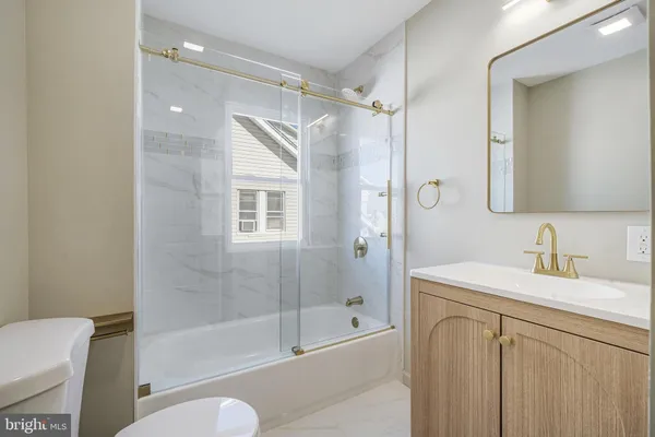 a bathroom with a sink toilet tub and shower