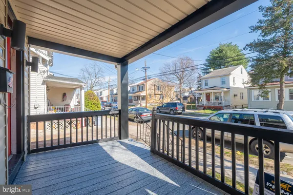 a view of a porch with wooden floor and fence
