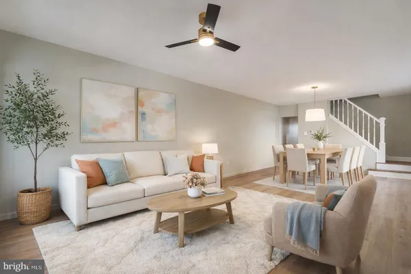 a living room with furniture and a chandelier