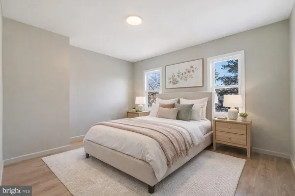 a bedroom with a bed and a night stand