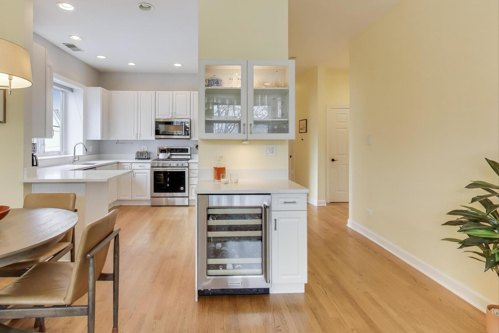 3616 North Janssen Avenue, Unit 2S Chicago, IL 60613 - Photo 6 of 22 a kitchen with stainless steel appliances a stove a sink and a refrigerator