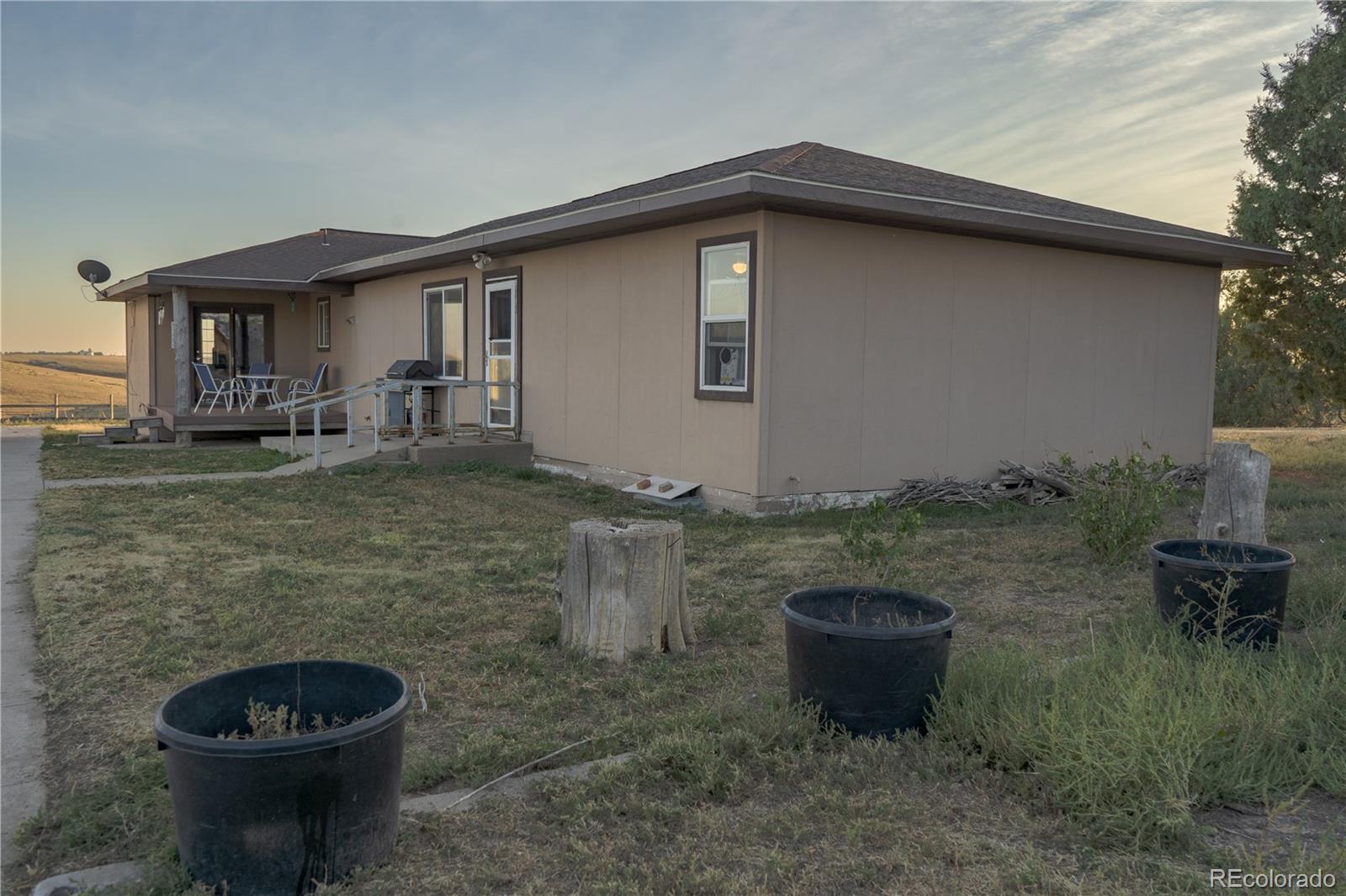 17150 County Rd PP Wray, CO 80758 - Photo 2 of 48 a view of a backyard with table and chairs and plants