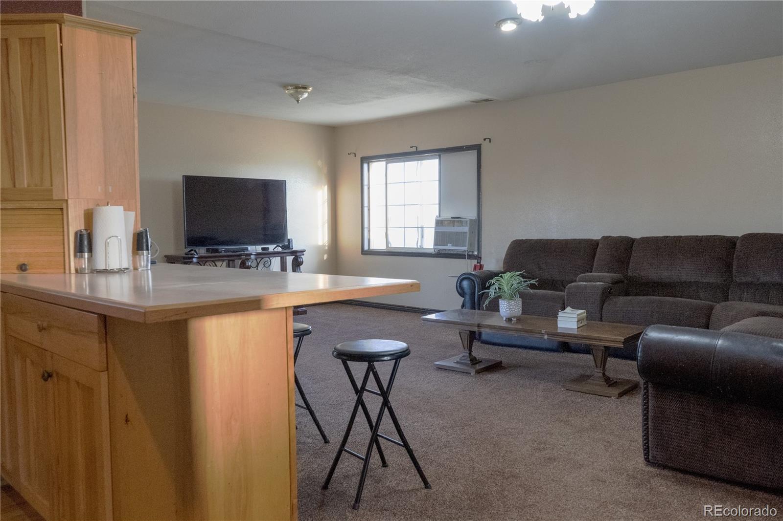 17150 County Rd PP Wray, CO 80758 - Photo 24 of 48 a living room with furniture and a flat screen tv