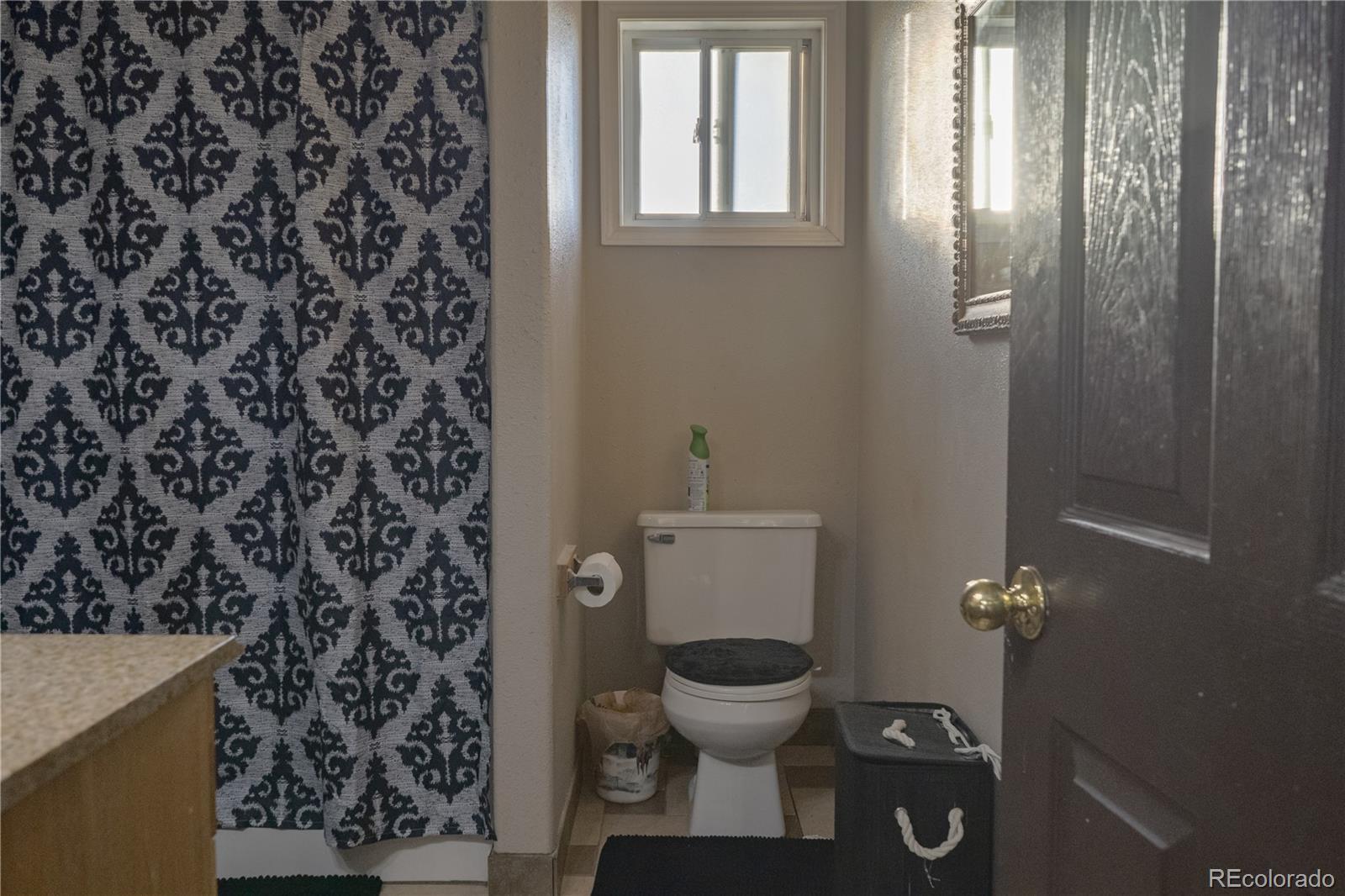 17150 County Rd PP Wray, CO 80758 - Photo 29 of 48 a white toilet sitting next to a shower curtain