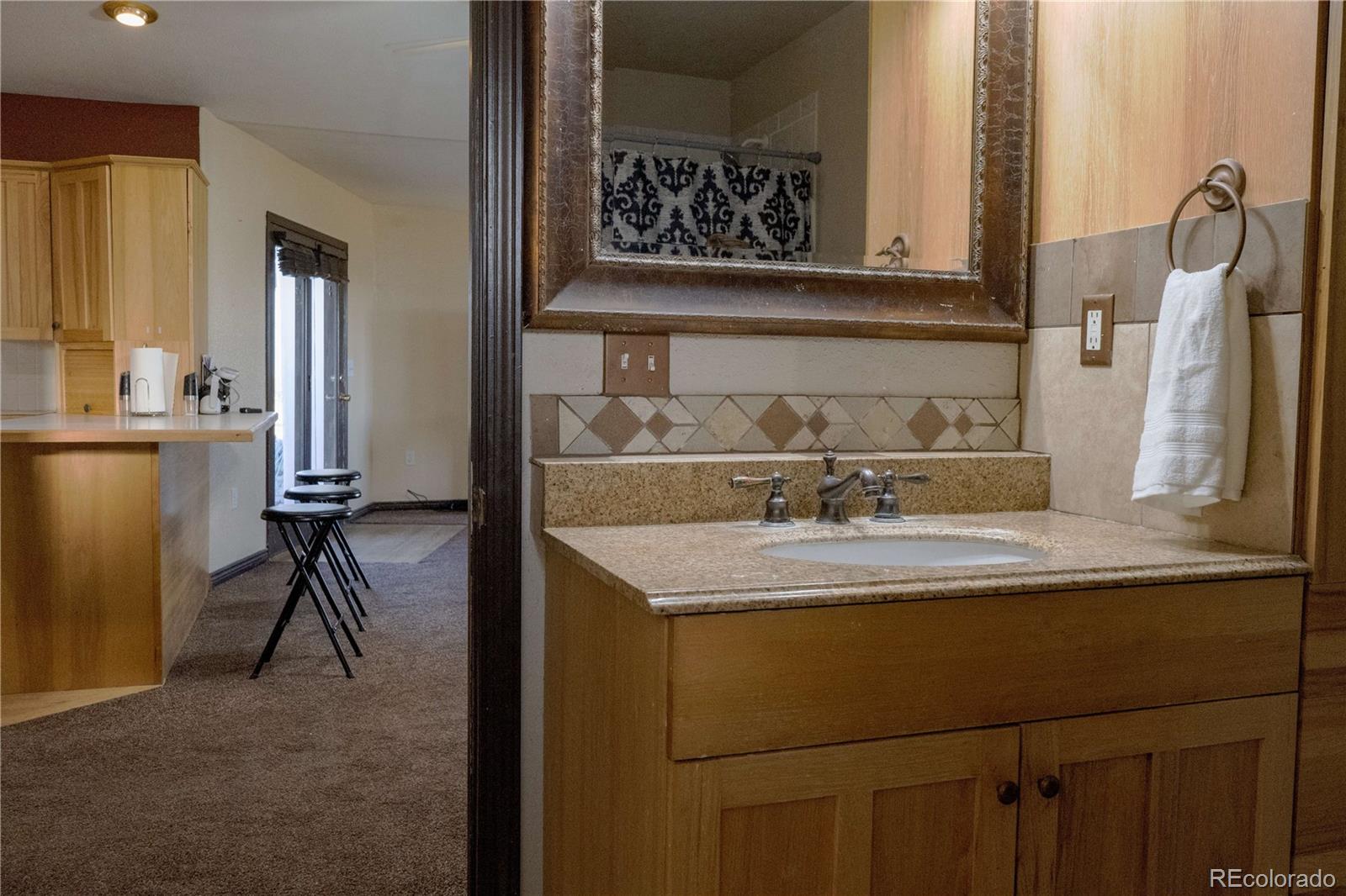 17150 County Rd PP Wray, CO 80758 - Photo 30 of 48 a room with a sink and a mirror