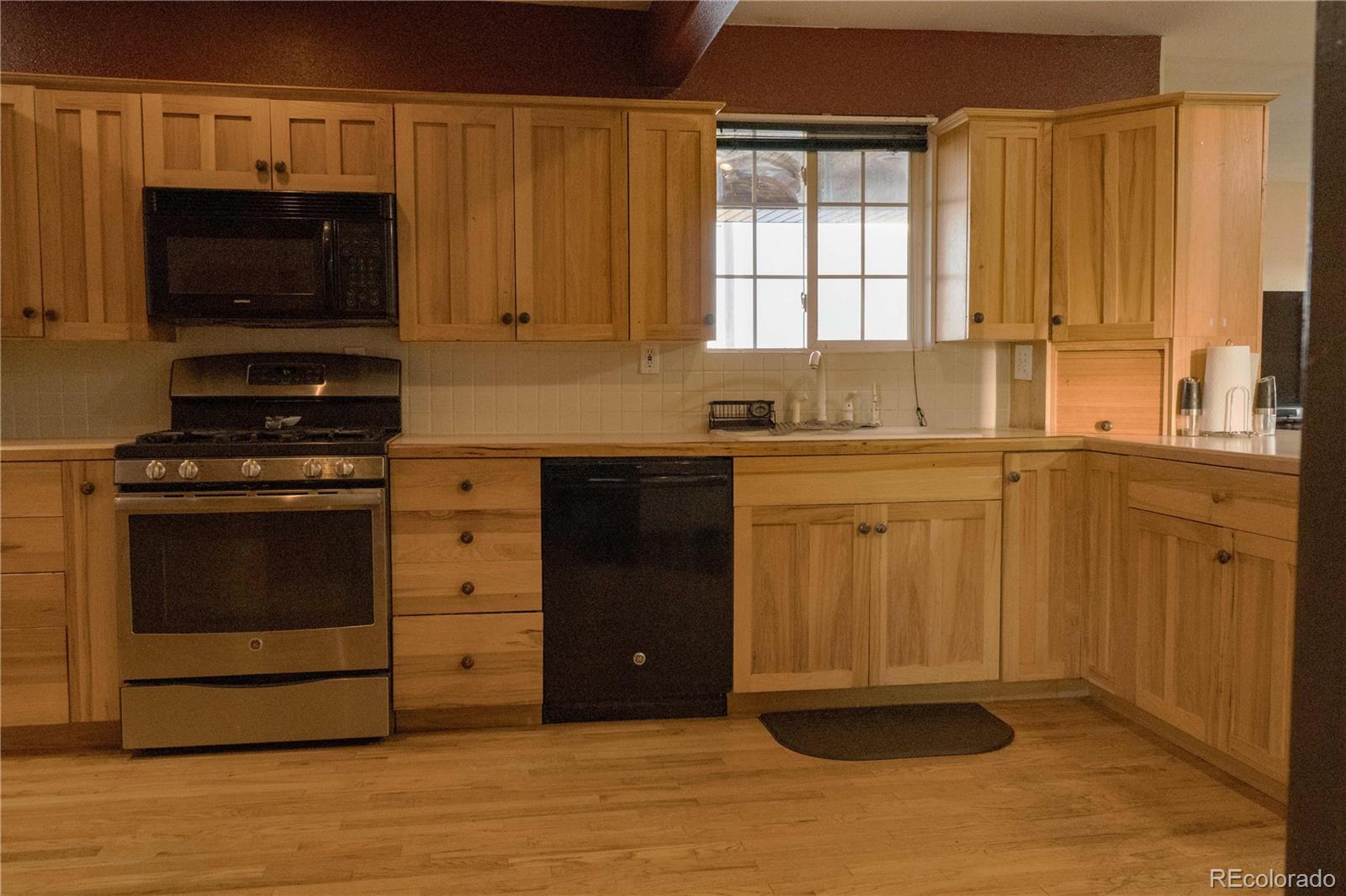 17150 County Rd PP Wray, CO 80758 - Photo 32 of 48 a kitchen with stainless steel appliances granite countertop a stove a microwave and a sink