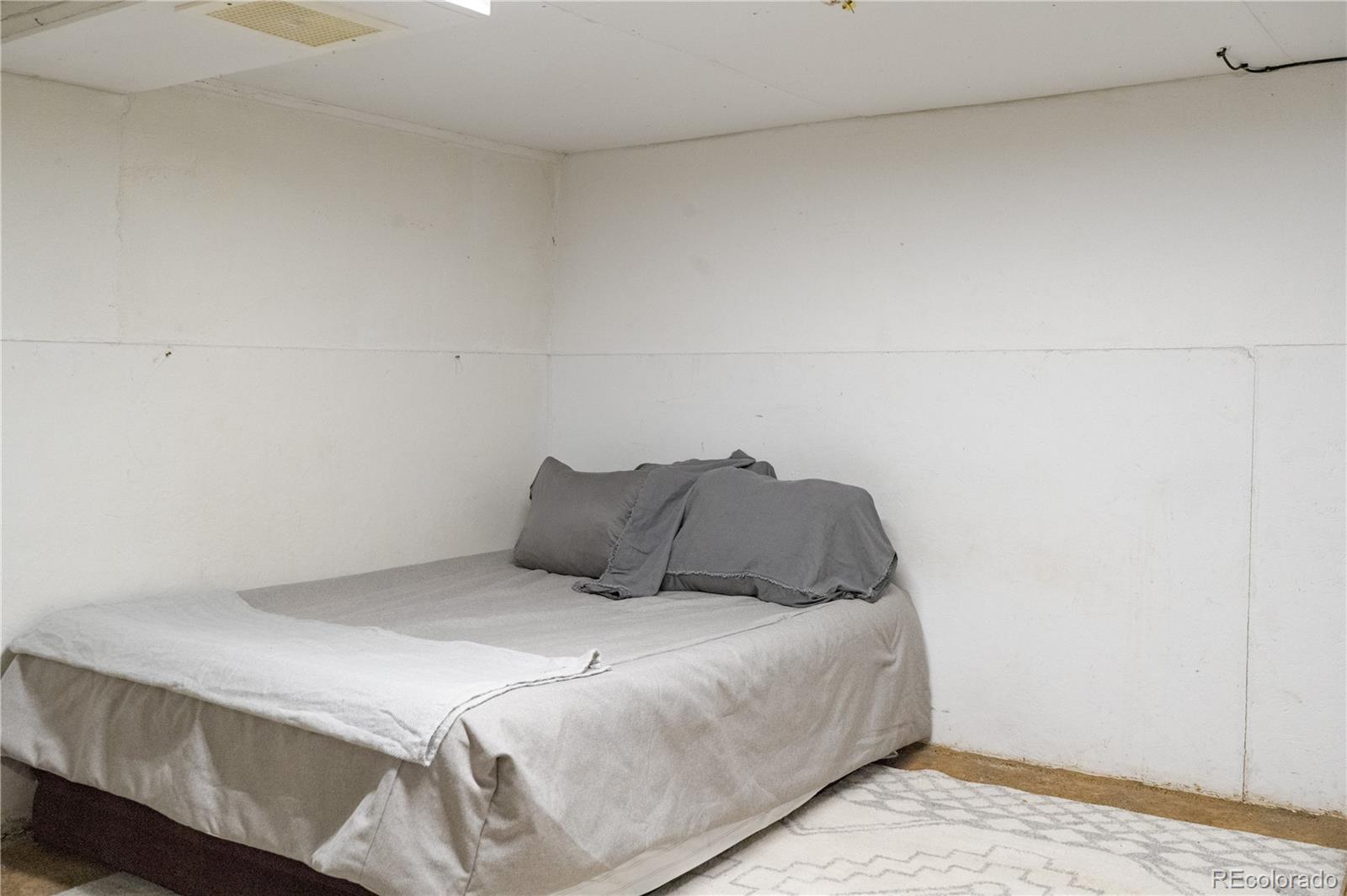 17150 County Rd PP Wray, CO 80758 - Photo 48 of 48 a bedroom with a bed and a night stand