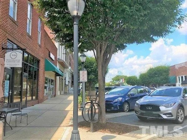 a view of street with parked cars