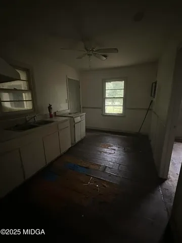 a kitchen with cabinets and black stainless steel appliances