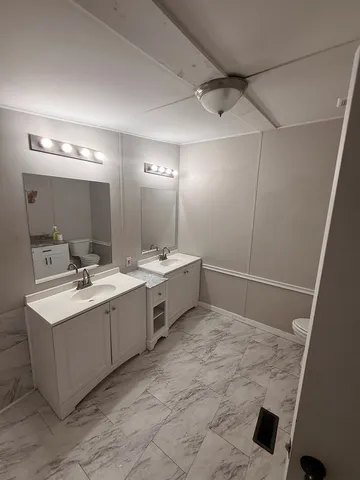 a bathroom with a sink vanity and mirror