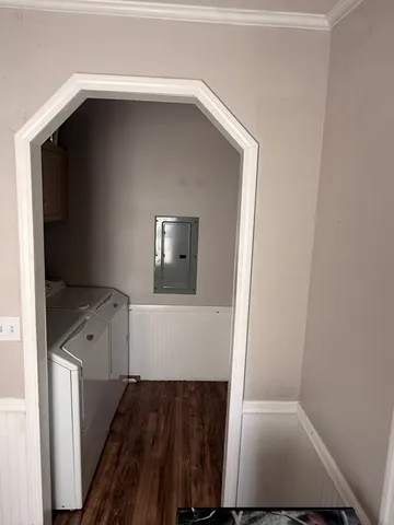 a view of an empty room with wooden floor