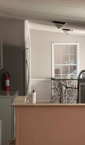 a kitchen with granite countertop a stove sink and microwave