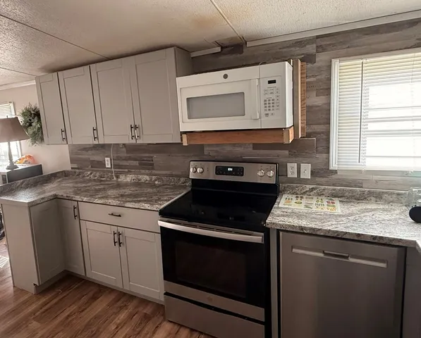 a kitchen with stainless steel appliances a refrigerator and a sink