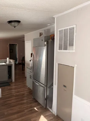 a view of a refrigerator in kitchen and wooden floor