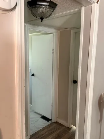 a view of a hallway with wooden floor