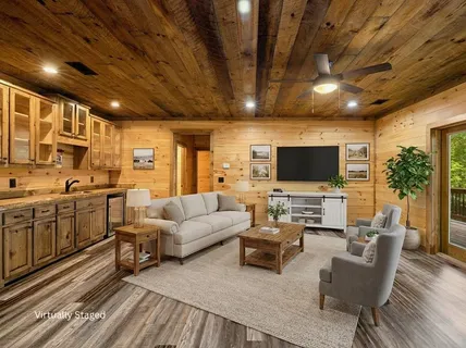 a view of a room with wooden floor and furniture
