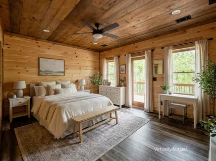 a bedroom with a large bed and a flat tv screen on dresser