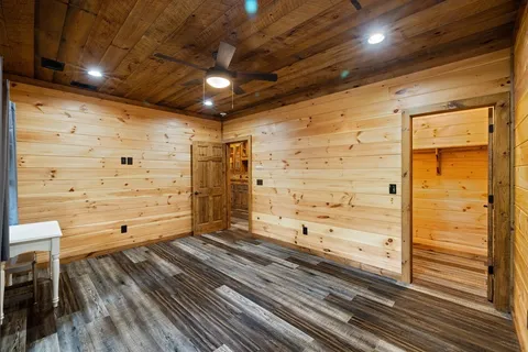 a bathroom with a granite countertop sink a large mirror and a bathtub