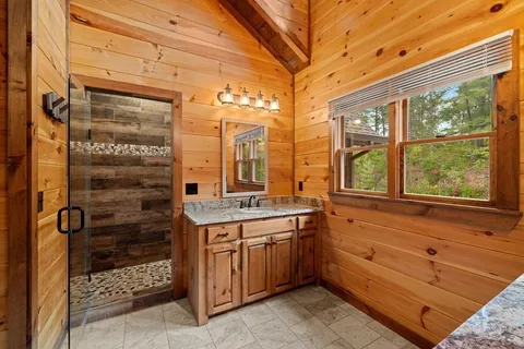 a bathroom with a granite countertop shower
