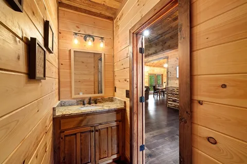a bathroom with a granite countertop shower a toilet and a sink