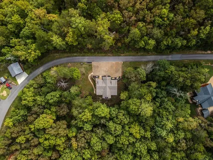 an aerial view of a house with yard