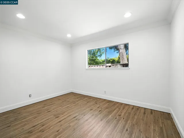 a view of room with wooden floor and window