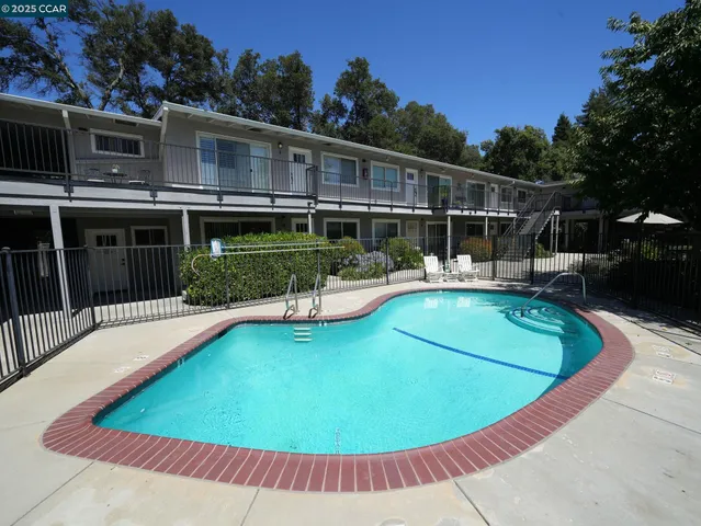 a view of a house with swimming pool and porch