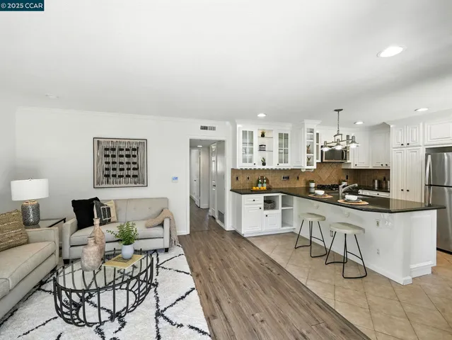 a kitchen with stainless steel appliances a refrigerator and cabinets