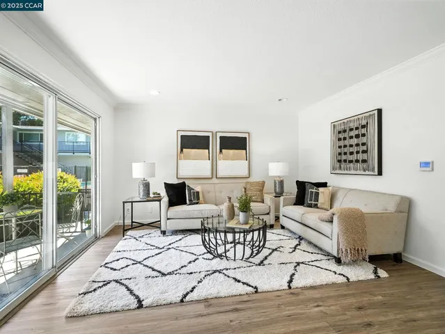 a living room with furniture and a floor to ceiling window
