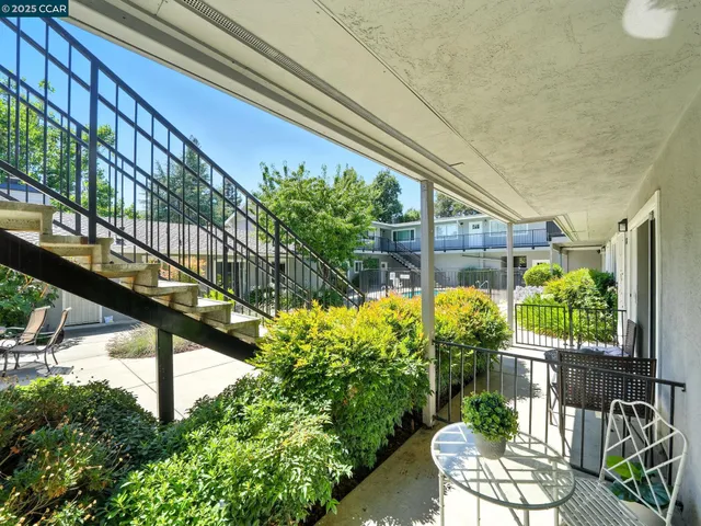 a view of a chairs and table in the balcony