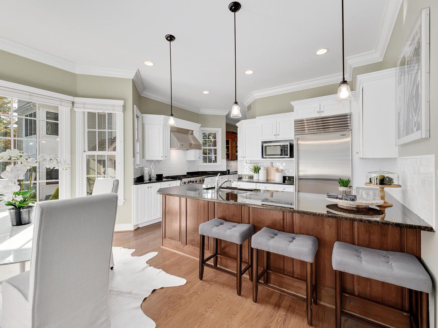 237 North County Line Road Hinsdale, IL 60521 - Photo 9 of 25 a kitchen with stainless steel appliances granite countertop a stove a sink a refrigerator a kitchen island a table and chairs