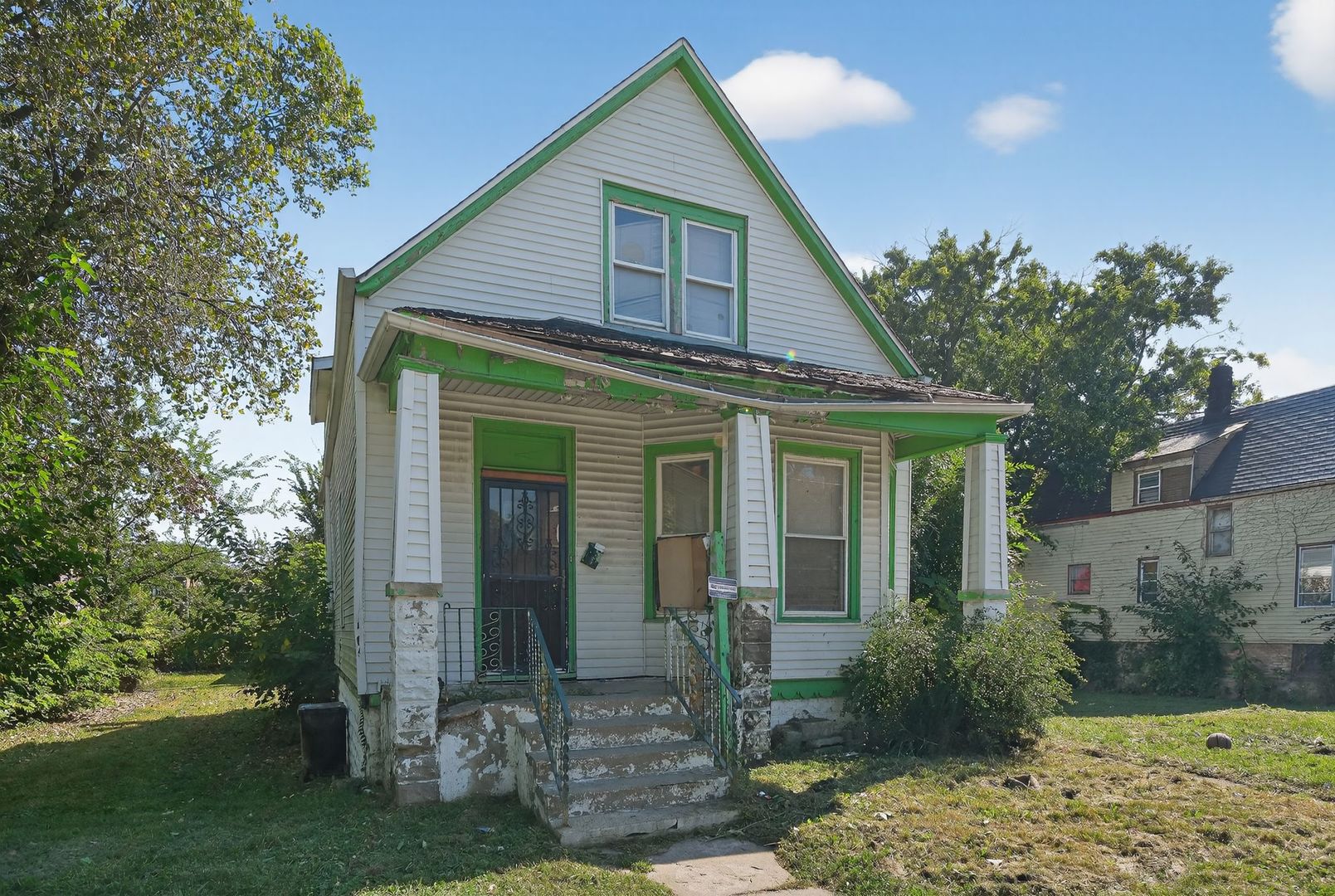 6731 South Aberdeen Street Chicago, IL 60621 - Photo 3 of 13 a view of a brick house next to a yard with potted plants