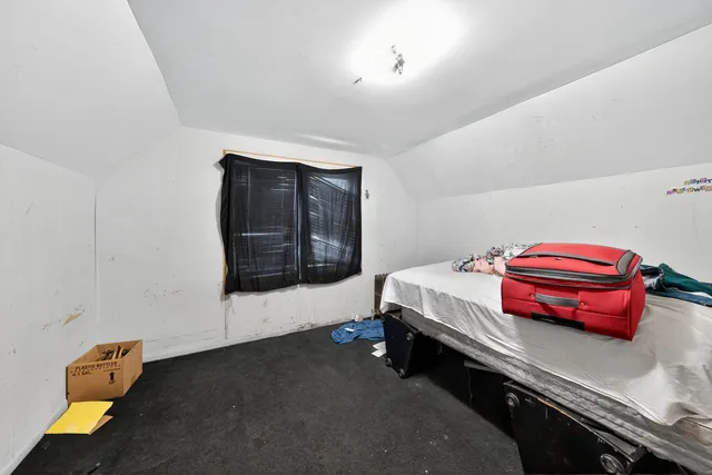 a room with a bed and a dresser