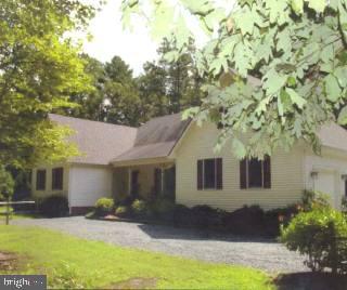 a front view of a house with yard and seating space