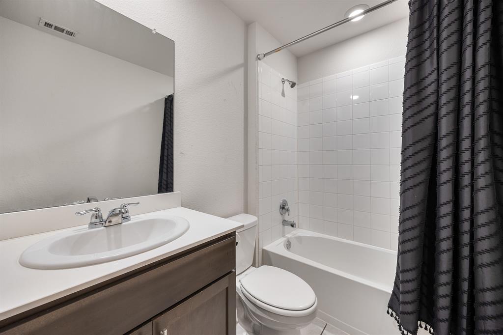 620 Gunsmoke Trail Princeton, TX 75407 - Photo 15 of 37 a bathroom with a sink a toilet a mirror a bathtub and shower