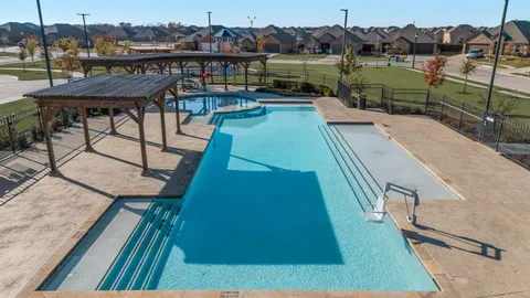 a view of swimming pool with outdoor seating