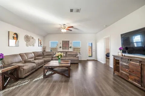 a living room with furniture and a flat screen tv