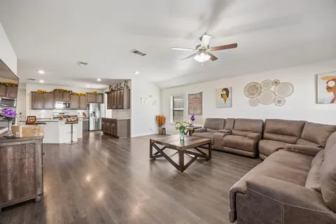 a living room with furniture and kitchen view