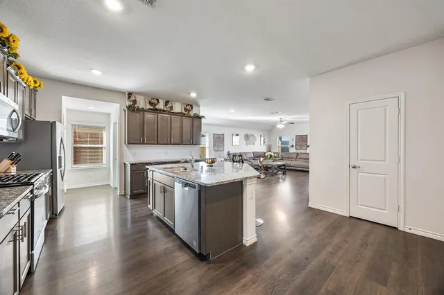 a kitchen with a stove and a wooden floors
